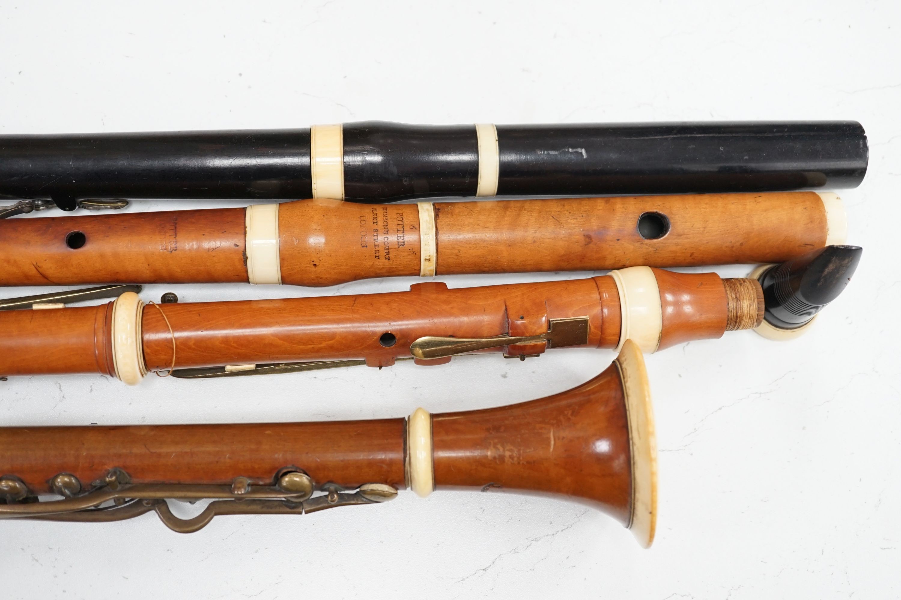 Two 19th century flutes by W. Potter, one in boxwood, the other ebony, and two 19th century boxwood clarinets, one by Dollard, the other by Lazarus